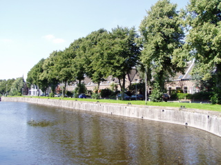 Canal in summer in front of monument house Utrecht